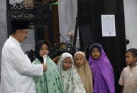 Wawali Abdul Harris Bobihoe yang mengenakan kemeja koko putih serta kopiah hitam.